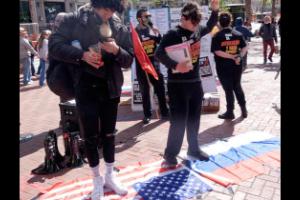 Standing on the American and Russian flags at the April 2 protests.
