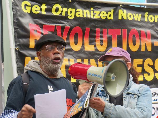 May 5th, NYC, Carl Dix on bullhorn speaking to people in SoHo.