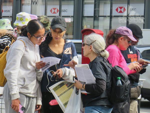 May 5th, NYC, passing out "We Are the Revcoms" broadsheet in SoHo.