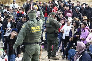 Border patrol hands out bracelets to asylum seekers waiting to cross to U.S. near Tijuana, Mexico, Monday, May 8, 2023.