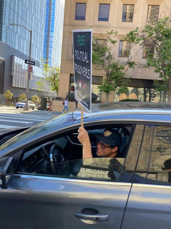 San Francisco, June 21: Commuter holds "Free Political Prisoners in Iran."
