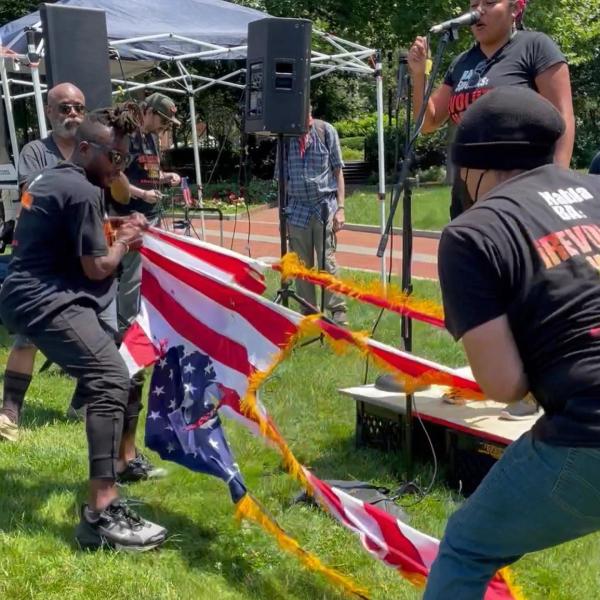 Revcoms tear apart and burn the U.S. flag, July 4 in front of Independence Hall, Philadelphia.
