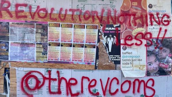 Austin, Texas, RevComs decorated wall with RevCom posters.