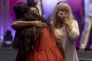 Attendees embrace during a church service for victims of the fire in Hawai'i