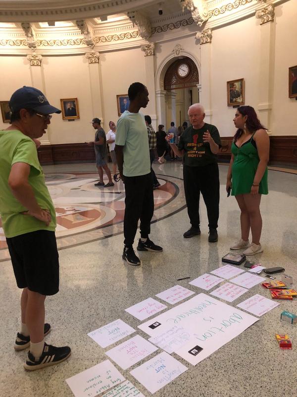 Revcoms saturate Capitol Rotunda, Austin, Texas.