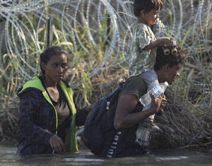 Immigrants in river, barbed wire