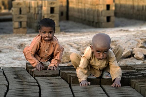 Afghan children work in a brick factory near Kabul, Afghanistan, July 26, 2022.