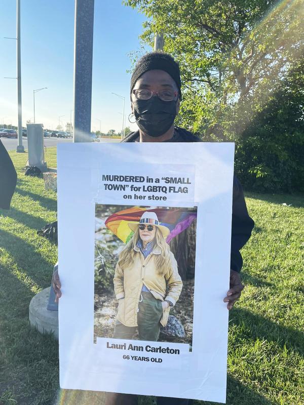 Chicago RevComs sign about LGBTQ and to protest Aldean's "small town."