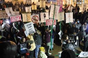 Large, diverse crowd of protesters with "Stop Cop City" signs