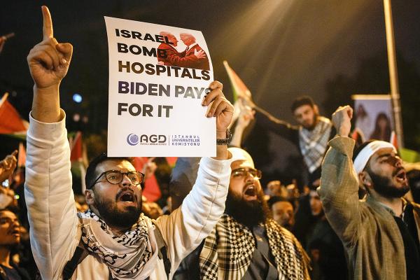 Turkey, protester with sign "Israel Bomb Hospitals Biden Pays For It"  at U.S. Consulate, October 18, 2023.
