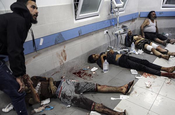 Wounded Palestinians lie on the floor in al-Shifa hospital in Gaza City, October 17, 2023.