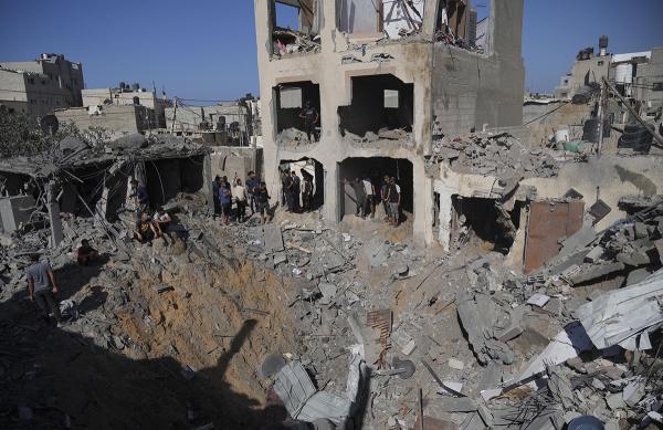 Palestinians look at the destruction from the Israeli bombardment of the morgue in Gaza Strip, November 7, 2023.