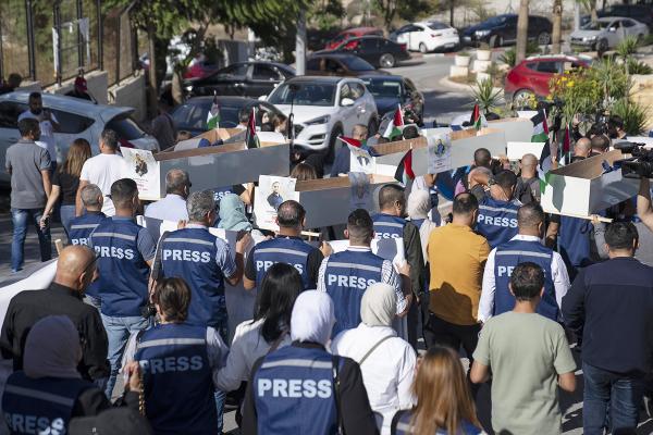 Palestinian journalists carry mock coffins of dead Palestinian journalists during a symbolic funeral in Ramallah, November 7, 2023. 