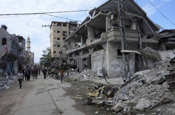 Palestinians examine rubble after Israeli bombardment of the Gaza Strip at the Bureij refugee camp, November 14, 2023