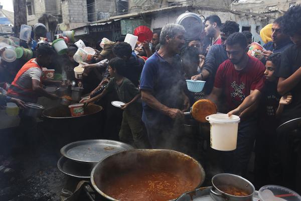 Last week, 9 out of 10 people in Gaza went at least one full day and night without food, according to the UN World Food Program. Here, Palestinians line up for food in Rafah, November 13, 2023.