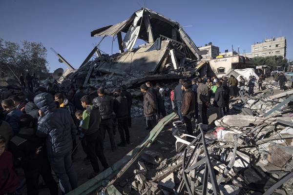 Palestinians search for survivors in the rubble of a residential building destroyed by an Israeli airstrike, in Rafah, December 15, 2023.