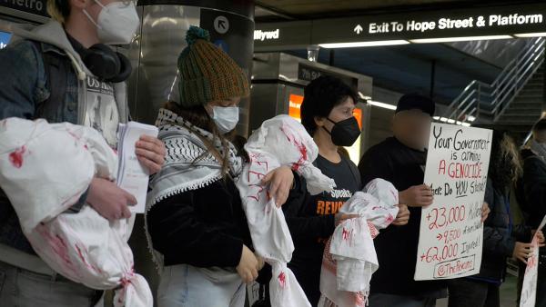 LA RevComs hold body bags symbolizing infants in memory of children killed in Gaza, January 11, 2024.