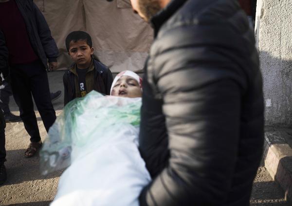 As death toll approaches 30,000, almost half of the dead are children. Here a relative holds the body of a child killed in Rafah, January 17, 2024.