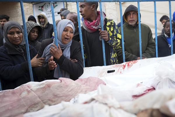 Palestinians at a hospital in Deir al Balah,l Gaza Strip, mourn the relatives killed in the Israeli air and ground offensive, January 26, 2024.