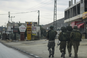Israeli soldiers patrol a Palestinian town, with the residents all driven out by "settler" violence