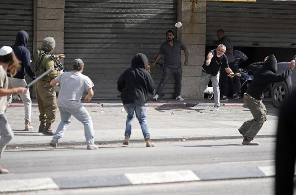 Palestinians and Israeli settlers clash in West Bank, October 13, 2022.