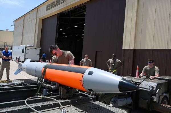 USAF squadron loads an unarmed B61-12 bomb, which can be outfitted with a nuclear warhead, on a B-2 Spirit bomber.