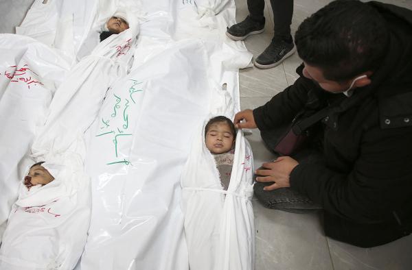 In the hospital morgue, Palestinian mourns children killed by the Israeli bombardment of southern Gaza Strip, March 29, 2024. 
