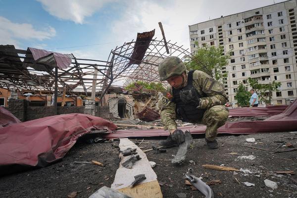 Inspecting fragments of a Russian air bomb that hit a living area, injuring ten, in Kharkiv, Ukraine, May 22, 2024.