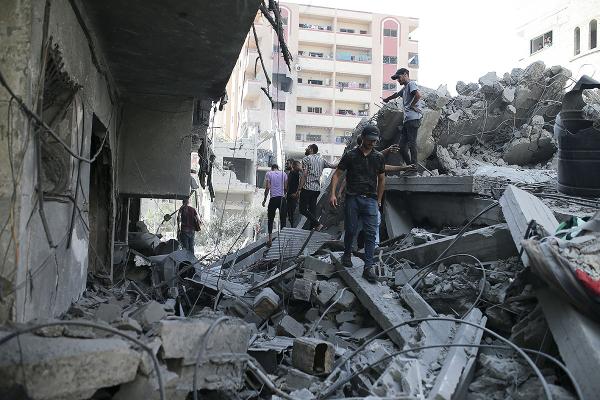 Palestinians search rubble from the Israeli bombing in Nuseirat refugee camp, Gaza Strip, June 8, 2024.