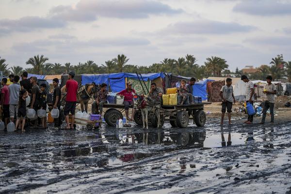 Israel's war in Gaza has decimated the strip's water systems while simultaneously displacing the vast majority of the population. Palestinians fill water jugs near one of the few functioning sources, June 20, 2024.