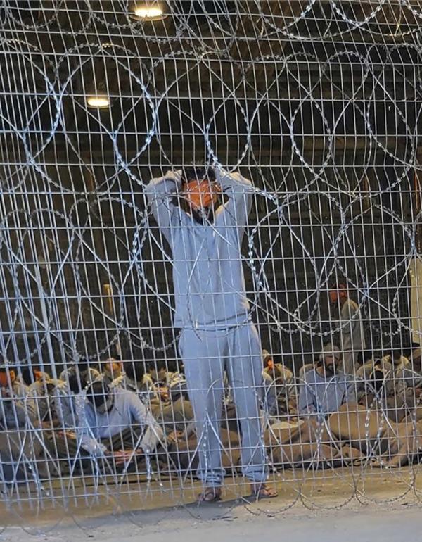 Blindfolded Palestinian prisoners captured in the Gaza Strip by Israeli forces at a detention facility, winter 2023.