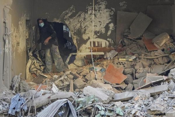 Woman searches for her belongings after Israeli airstrike on Beirut, Lebanon, October 11, 2024.