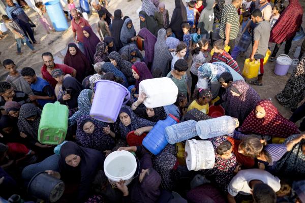 Displaced Palestinians queue for water at makeshift tent camp in Khan Younis, July 1, 2024.