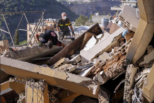 Searching for victims in the rubble of a destroyed building hit in an Israeli airstrike on Tuesday night, in Barja, Lebanon