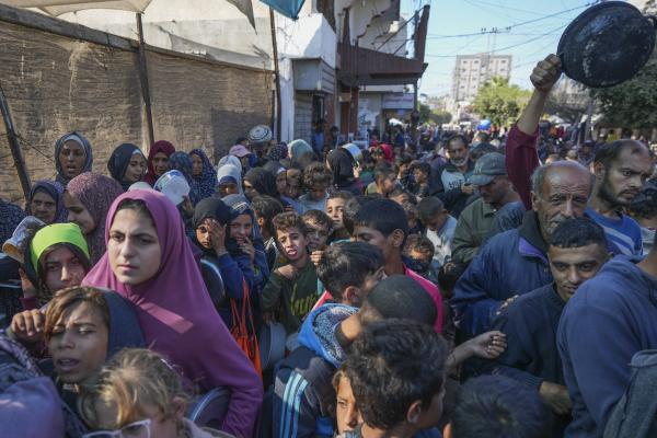 Palestinians queue for food in Deir al-Balah, Gaza Strip, November 18, 2024. 