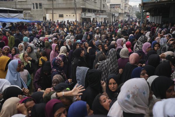 Palestinians gather to get food at a distribution center in Deir al-Balah, Gaza Strip, November 29, 2024.
