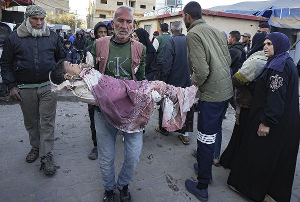 A Palestinian child wounded during the Israeli bombardment of the Gaza Strip is carried to the Al-Aqsa Hospital, December 19, 2024.