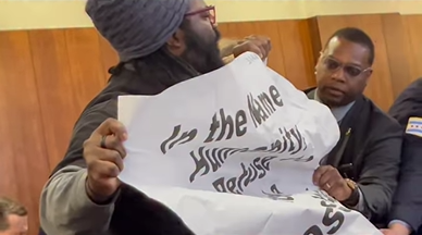 Revcom Corp being pushed out of City Council meeting, Chicago, Dec 16, 2024.