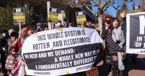 Protest Jan 20, 2025: This Whole System Is Rotten and Illegitimate, We Need and We Demand…” banner at the rally at Telegraph and Bancroft
