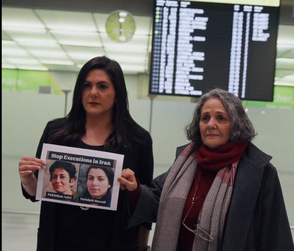Mariam Claren and her mother Nahid Taghavi hold sign "Stop Executions" of Iran political prisoners.