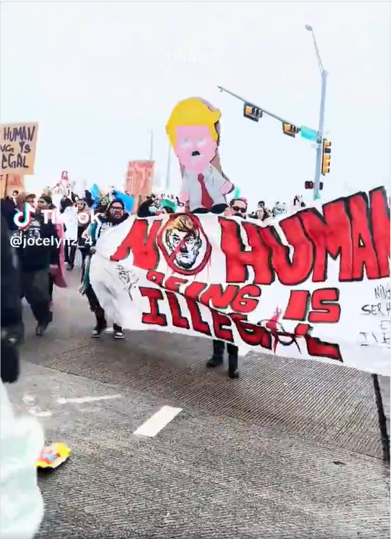 Dallas pro-immigrant march January 28, banner says "No Human Being is Illegal." 