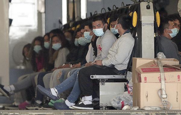 Migrants, shackled, sit on a military aircraft at Fort Bliss in El Paso, Texas, January 30, 2025.