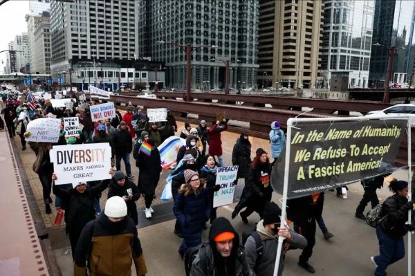 Chicago Revcom Corps banner leads protest up Michigan Avenue, February 6, 2025.