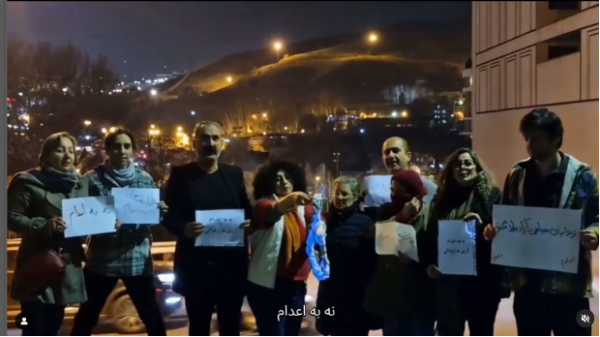 Narges Mohammadi burns hated noose at Evin Prison's gate.