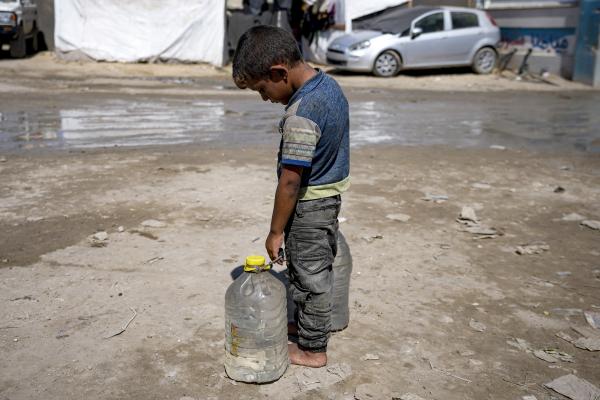 Young boy in Gaza with cans to get water, August 29, 2024.