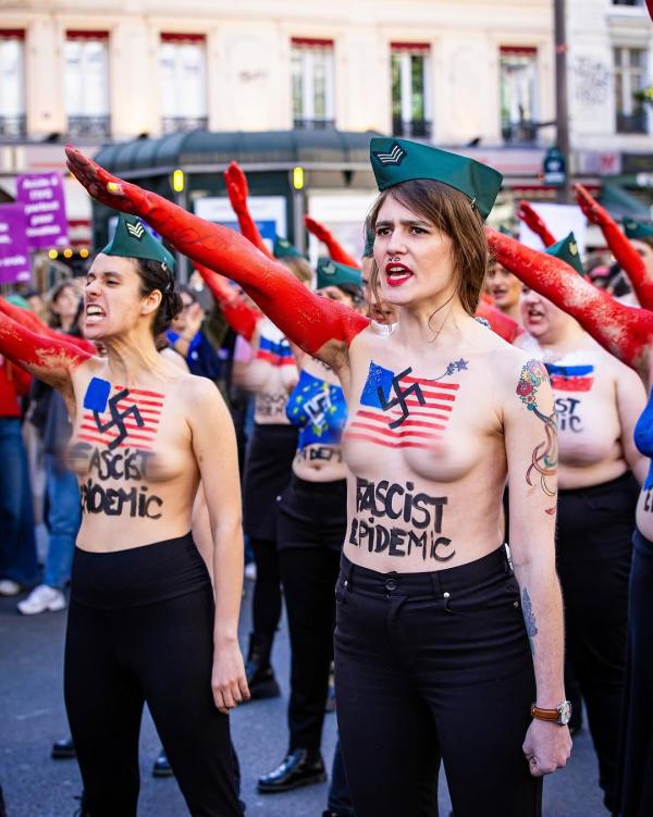 Femen France. women with US flags and swastikas painted on their bare chests.ed 