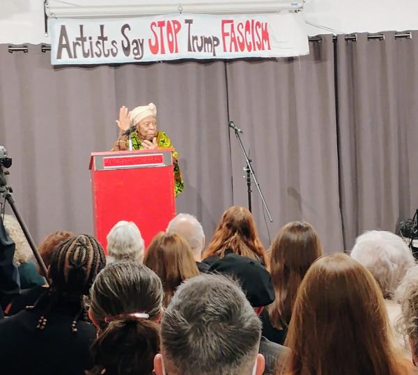 Rashidah Ismaili, performs at Artists Say Stop Trump Fascism