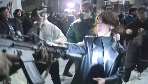 Ahn Gwi-ryeong is seen in screen-grab from video captured by JTBC grabbing an armed soldier’s gun