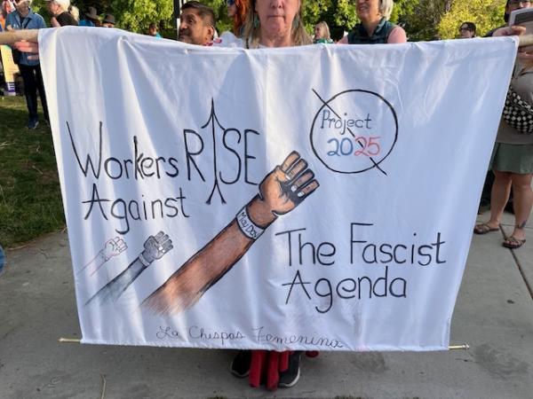May Day protest in Albuquerque, New Mexico. Banner says Workers Rise Against The Fascist Agenda.