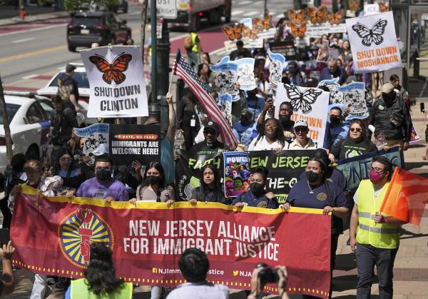 March to Philadelphia capitol is led by NJ banner for immigrants.